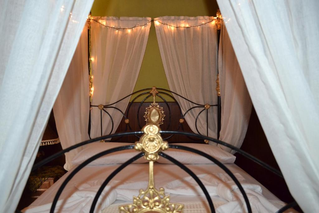 Ornate iron canopy bed with fairy lights